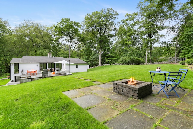 23 Wyndover Ln N, Stamford, CT 06902 - view of grassy yard with a fire pit, a patio area, a deck, and view of scattered trees