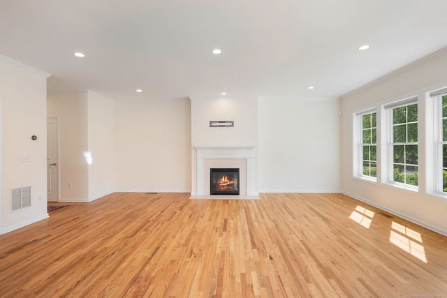 51 Lexington Gdns Unit 51, North Haven, CT 06473 - unfurnished living room featuring ornamental molding, recessed lighting, baseboards, light wood-style flooring, and a fireplace with flush hearth