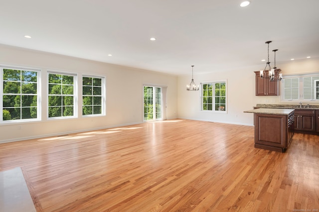 51 Lexington Gdns Unit 51, North Haven, CT 06473 - unfurnished living room with a chandelier, light wood-style flooring, recessed lighting, ornamental molding, and baseboards