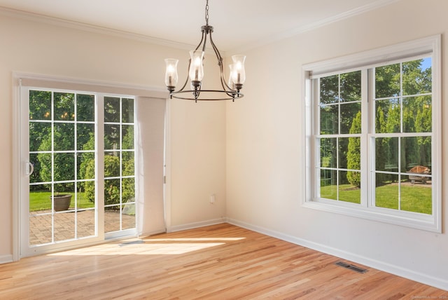 51 Lexington Gdns Unit 51, North Haven, CT 06473 - unfurnished dining area featuring a chandelier, plenty of natural light, baseboards, and ornamental molding