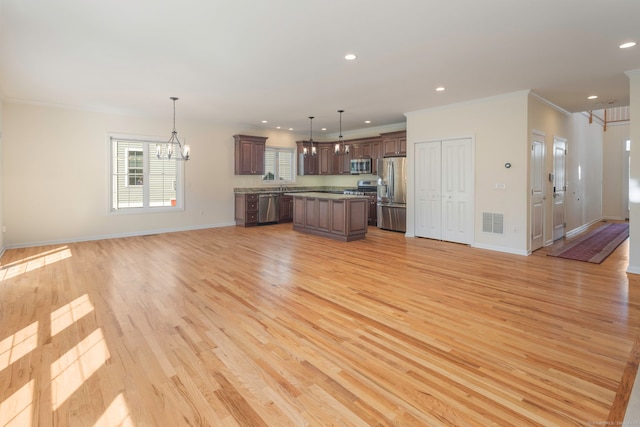51 Lexington Gdns Unit 51, North Haven, CT 06473 - unfurnished living room featuring light wood-style floors, ornamental molding, recessed lighting, baseboards, and a chandelier