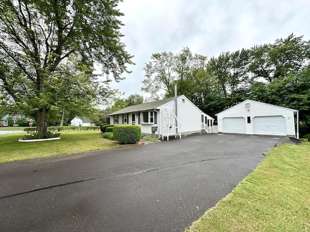 107 Montemerlo Ave, Windsor Locks, CT 06096 - view of front of house with an outbuilding, a front yard, a detached garage, and a chimney