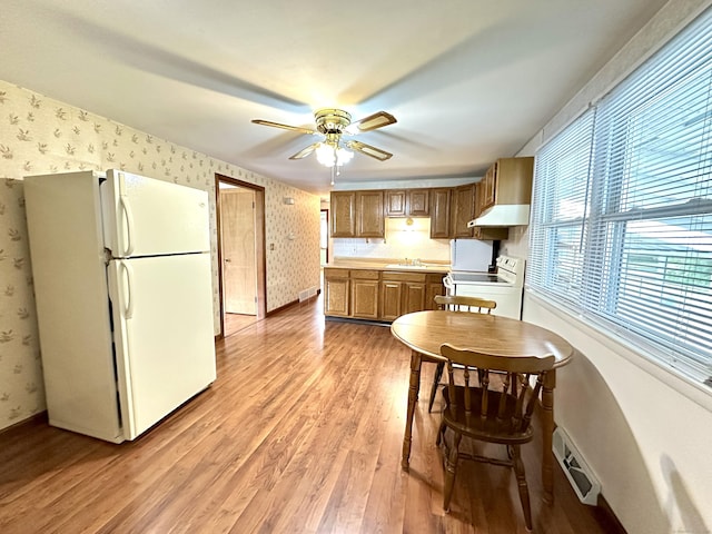 107 Montemerlo Ave, Windsor Locks, CT 06096 - kitchen featuring white appliances, wallpapered walls, under cabinet range hood, light wood-style flooring, and baseboards