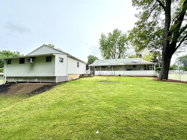 107 Montemerlo Ave, Windsor Locks, CT 06096 - rear view of property with a sunroom and an AC wall unit