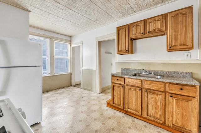 67 Ash St, Bridgeport, CT 06605 - kitchen with freestanding refrigerator and brown cabinets