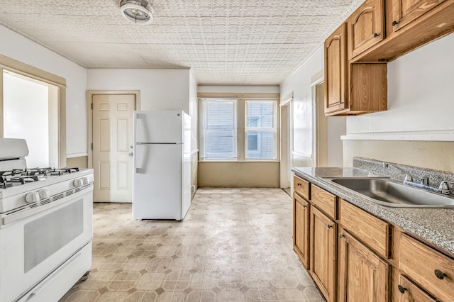 67 Ash St, Bridgeport, CT 06605 - kitchen with white appliances and brown cabinetry