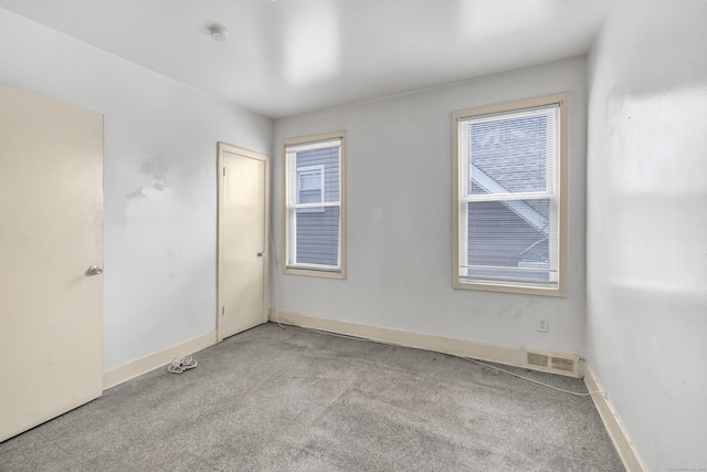 67 Ash St, Bridgeport, CT 06605 - carpeted empty room with a smoke detector and baseboards