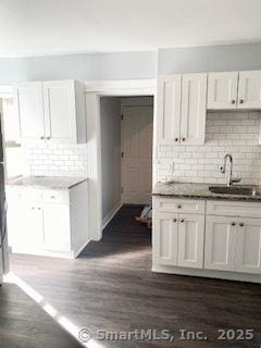 67 Ash St, Bridgeport, CT 06605 - kitchen with tasteful backsplash, white cabinetry, and dark wood-type flooring