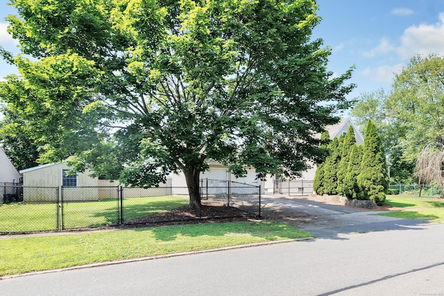 855 Stratford Rd, Stratford, CT 06615 - view of property hidden behind natural elements with asphalt driveway, a garage, and a gate