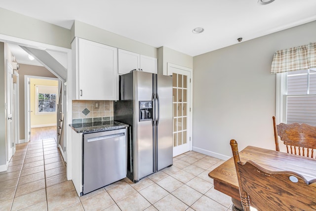 855 Stratford Rd, Stratford, CT 06615 - kitchen featuring stainless steel appliances, white cabinetry, light tile patterned flooring, tasteful backsplash, and dark stone counters