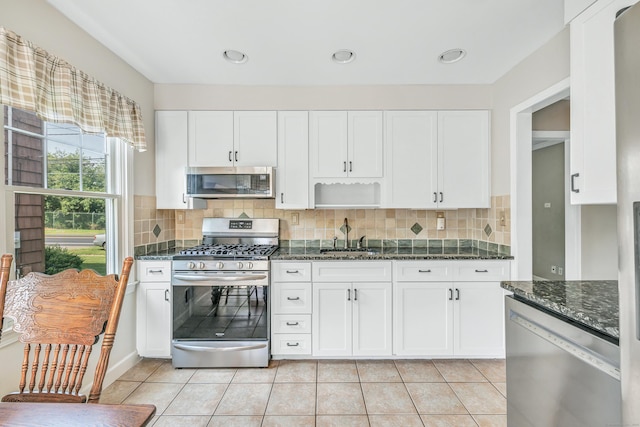 855 Stratford Rd, Stratford, CT 06615 - kitchen with appliances with stainless steel finishes, white cabinetry, dark stone counters, and decorative backsplash