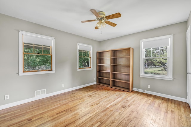 855 Stratford Rd, Stratford, CT 06615 - empty room with healthy amount of natural light, hardwood / wood-style floors, and a ceiling fan