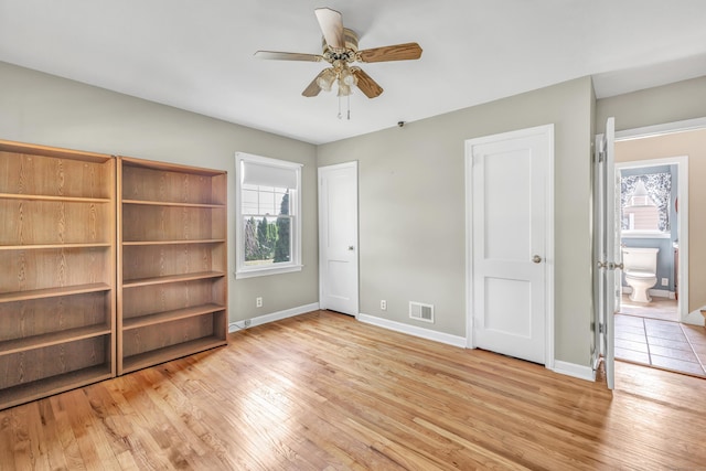 855 Stratford Rd, Stratford, CT 06615 - unfurnished bedroom featuring multiple windows, wood finished floors, and ensuite bath