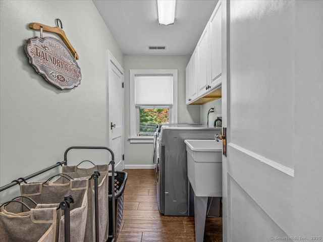 102 Columbus Ave, Meriden, CT 06451 - laundry room with cabinet space, washing machine and dryer, dark wood finished floors, and baseboards