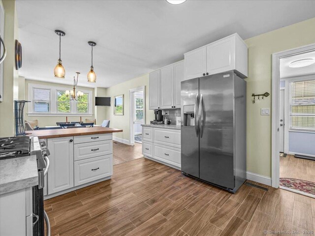 102 Columbus Ave, Meriden, CT 06451 - kitchen with stainless steel appliances, baseboards, white cabinets, and dark wood-style flooring
