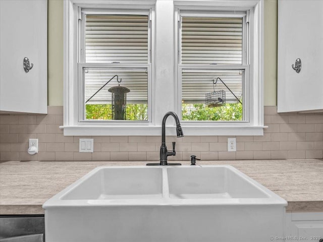 102 Columbus Ave, Meriden, CT 06451 - kitchen view of a sink, light countertops, white cabinetry, and tasteful backsplash