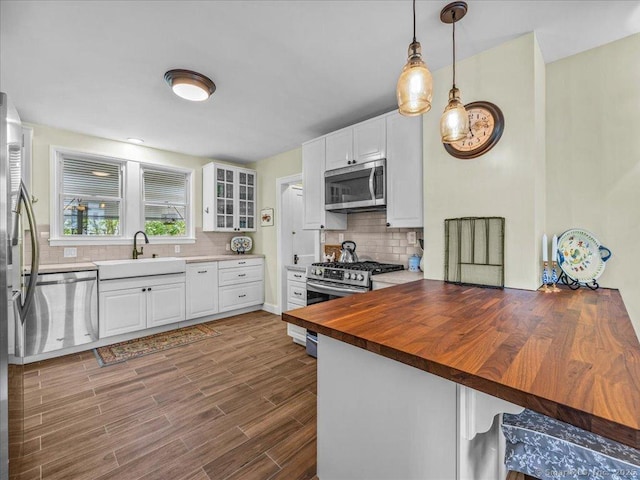 102 Columbus Ave, Meriden, CT 06451 - kitchen with stainless steel appliances, butcher block countertops, backsplash, and white cabinetry