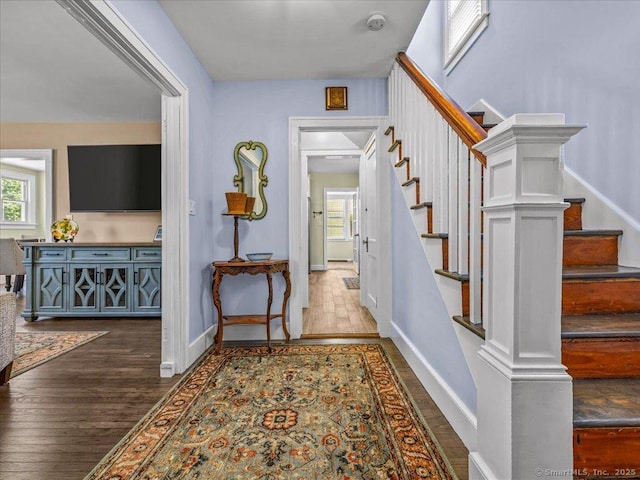 102 Columbus Ave, Meriden, CT 06451 - corridor featuring wood finished floors, healthy amount of natural light, stairs, and baseboards