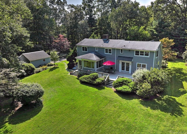 89 Pease Rd, Woodbridge, CT 06525 - back of property with a lawn, a chimney, and a wooden deck