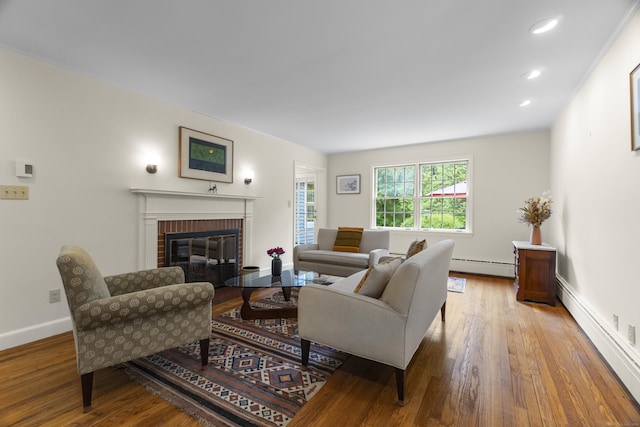 89 Pease Rd, Woodbridge, CT 06525 - living area featuring a baseboard heating unit, a fireplace, wood finished floors, and recessed lighting