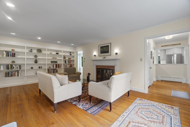 89 Pease Rd, Woodbridge, CT 06525 - living area featuring a baseboard heating unit, a brick fireplace, wood finished floors, baseboards, and recessed lighting