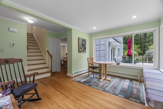 89 Pease Rd, Woodbridge, CT 06525 - living area with a baseboard radiator, wood finished floors, baseboards, ornamental molding, and stairway