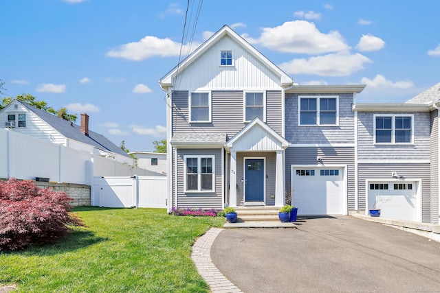 74 Sterling St, Fairfield, CT 06825 - view of front facade with driveway, a garage, and a gate