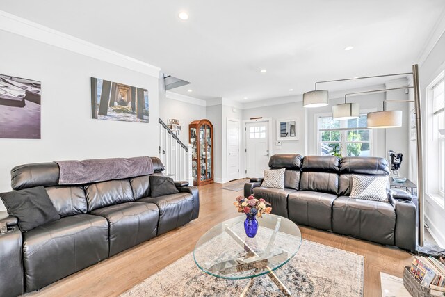74 Sterling St, Fairfield, CT 06825 - living room with stairway, ornamental molding, arched walkways, wood finished floors, and recessed lighting