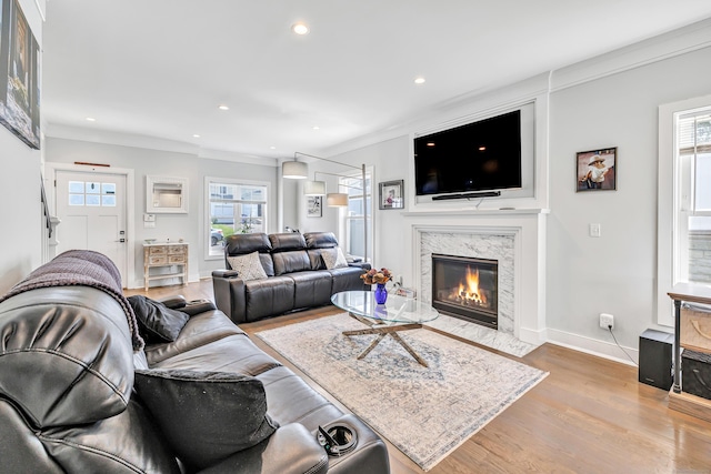 74 Sterling St, Fairfield, CT 06825 - living room with wood finished floors, plenty of natural light, recessed lighting, a high end fireplace, and baseboards