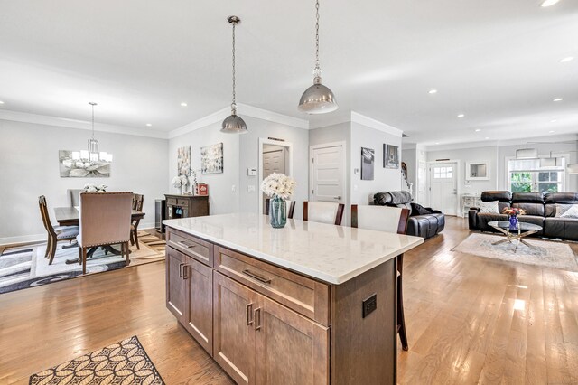 74 Sterling St, Fairfield, CT 06825 - kitchen with light wood finished floors, a kitchen island, recessed lighting, decorative light fixtures, and open floor plan