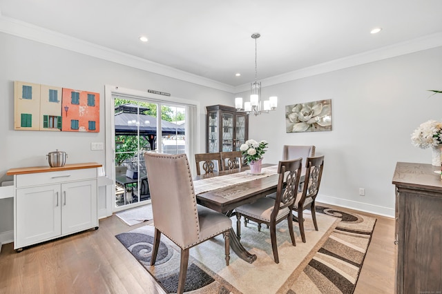 74 Sterling St, Fairfield, CT 06825 - dining area featuring light wood-type flooring, a chandelier, recessed lighting, crown molding, and baseboards