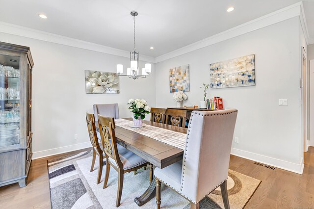 74 Sterling St, Fairfield, CT 06825 - dining area with a chandelier, light wood finished floors, baseboards, crown molding, and recessed lighting