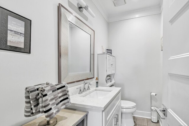 74 Sterling St, Fairfield, CT 06825 - bathroom with toilet, crown molding, vanity, and baseboards