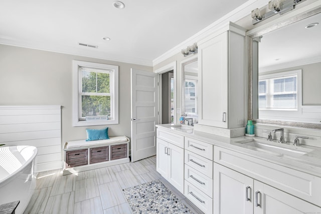 74 Sterling St, Fairfield, CT 06825 - full bathroom featuring ornamental molding, double vanity, a soaking tub, and recessed lighting