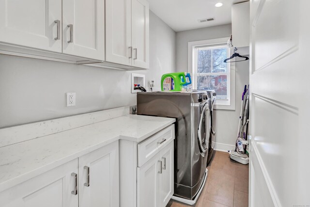 74 Sterling St, Fairfield, CT 06825 - washroom with washing machine and clothes dryer, cabinet space, baseboards, tile patterned floors, and recessed lighting