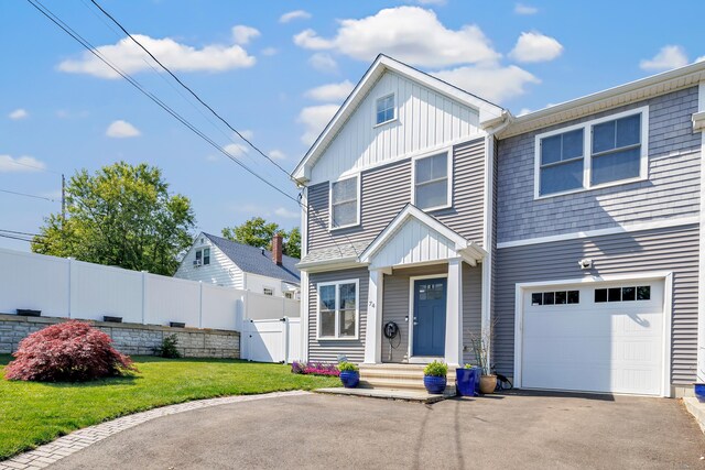 74 Sterling St, Fairfield, CT 06825 - view of front of property with a garage, board and batten siding, driveway, and a gate