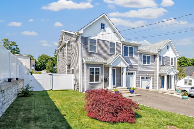 74 Sterling St, Fairfield, CT 06825 - view of front of home featuring a gate, an attached garage, driveway, and board and batten siding