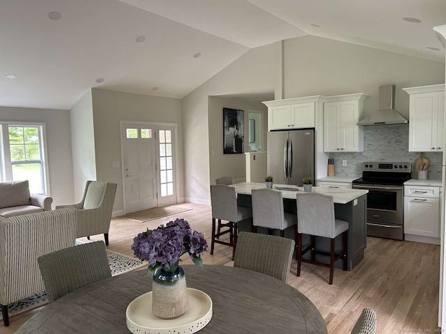 18 Great Meadow Rd, Redding, CT 06896 - dining area with light wood-type flooring and lofted ceiling