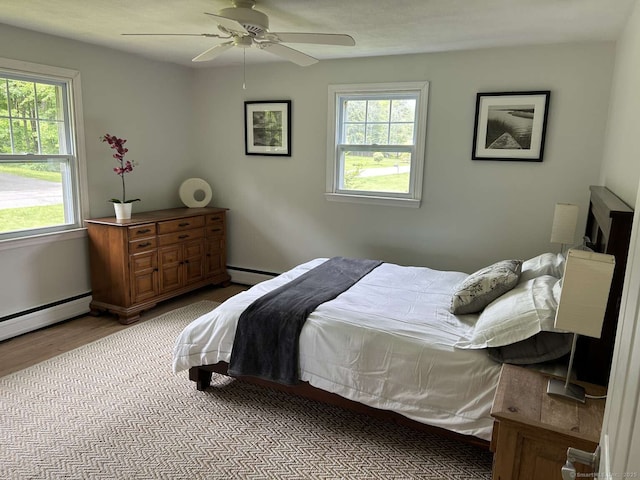 18 Great Meadow Rd, Redding, CT 06896 - bedroom with wood finished floors, a baseboard radiator, and a ceiling fan