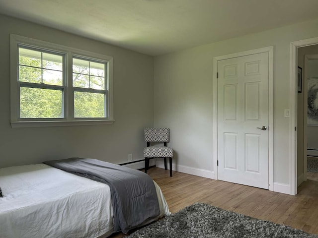 18 Great Meadow Rd, Redding, CT 06896 - bedroom with wood finished floors, baseboards, and a baseboard heating unit