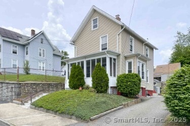25 Myrtle Ave, Ansonia, CT 06401 - view of front of house featuring a chimney and a sunroom