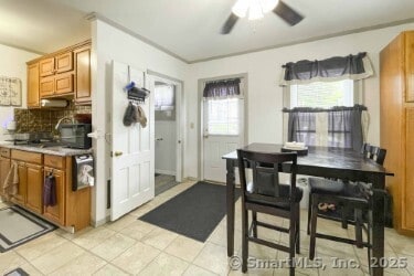 25 Myrtle Ave, Ansonia, CT 06401 - kitchen with ceiling fan, brown cabinets, decorative backsplash, and light tile patterned floors