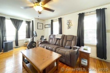 25 Myrtle Ave, Ansonia, CT 06401 - living area with plenty of natural light, a ceiling fan, and wood finished floors