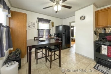 25 Myrtle Ave, Ansonia, CT 06401 - kitchen featuring black appliances, a ceiling fan, brown cabinets, backsplash, and light tile patterned flooring