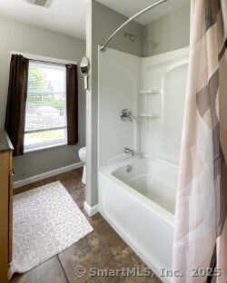 25 Myrtle Ave, Ansonia, CT 06401 - bathroom featuring toilet, shower / bath combo with shower curtain, baseboards, and vanity