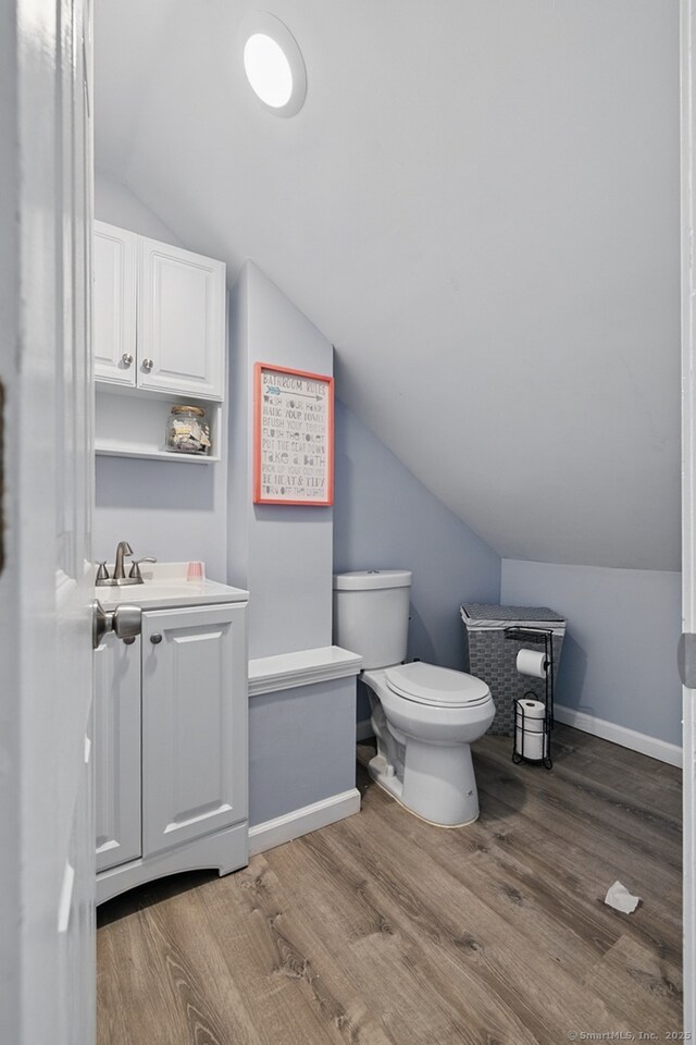 86 Chambers St, Waterbury, CT 06708 - bathroom with lofted ceiling, vanity, toilet, wood finished floors, and baseboards