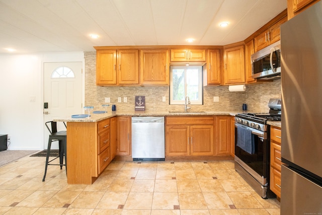 45 Twin Oaks Ln, Danbury, CT 06810 - kitchen with stainless steel appliances, a sink, a peninsula, tasteful backsplash, and recessed lighting