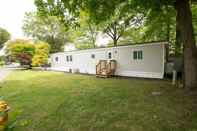45 Twin Oaks Ln, Danbury, CT 06810 - back of house with a lawn and central AC unit