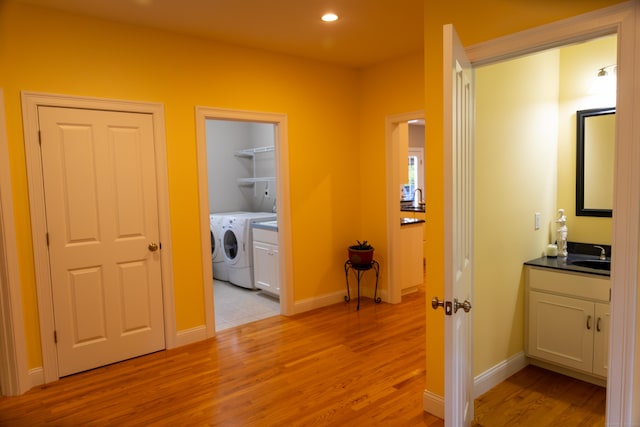 116 Case St, Canton, CT 06019 - hallway with light wood finished floors, separate washer and dryer, baseboards, recessed lighting, and a sink