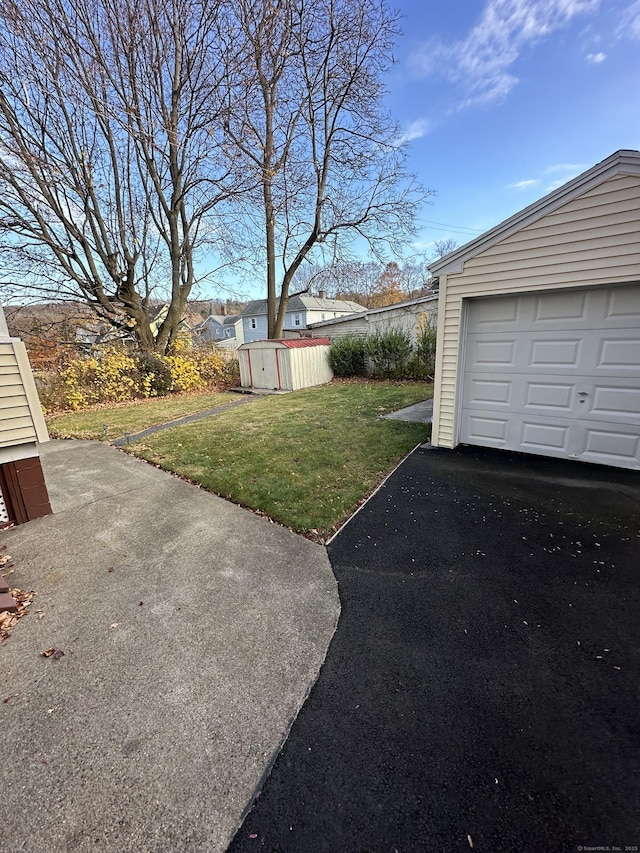 18 New St, Ansonia, CT 06401 - view of green lawn with an outdoor structure, a garage, and driveway
